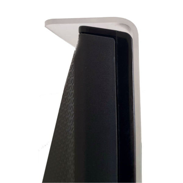 A close-up shot from above shows the top corner of a clear acrylic TV screen protector resting on the top edge of a black flat-screen television. The protector has a rounded corner and slightly overhangs the top and side of the TV. The texture of the back of the TV is visible. The background is plain white.