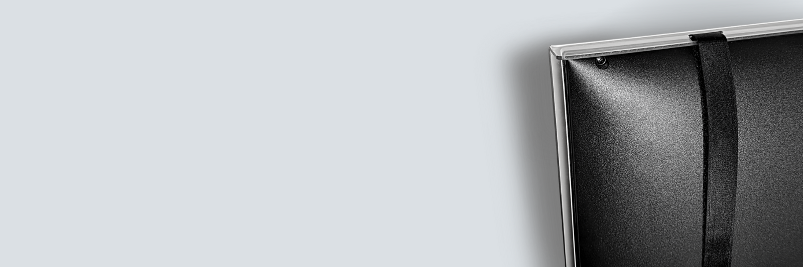 The back of a TV with a screen protector or enclosure attached.
